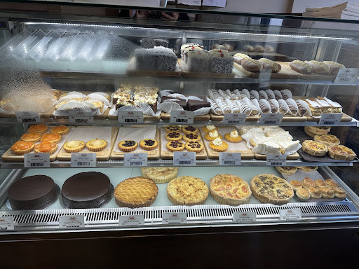 Sweet cabinet with cakes, tarts, and slices at Paris Mt Eden Bakery